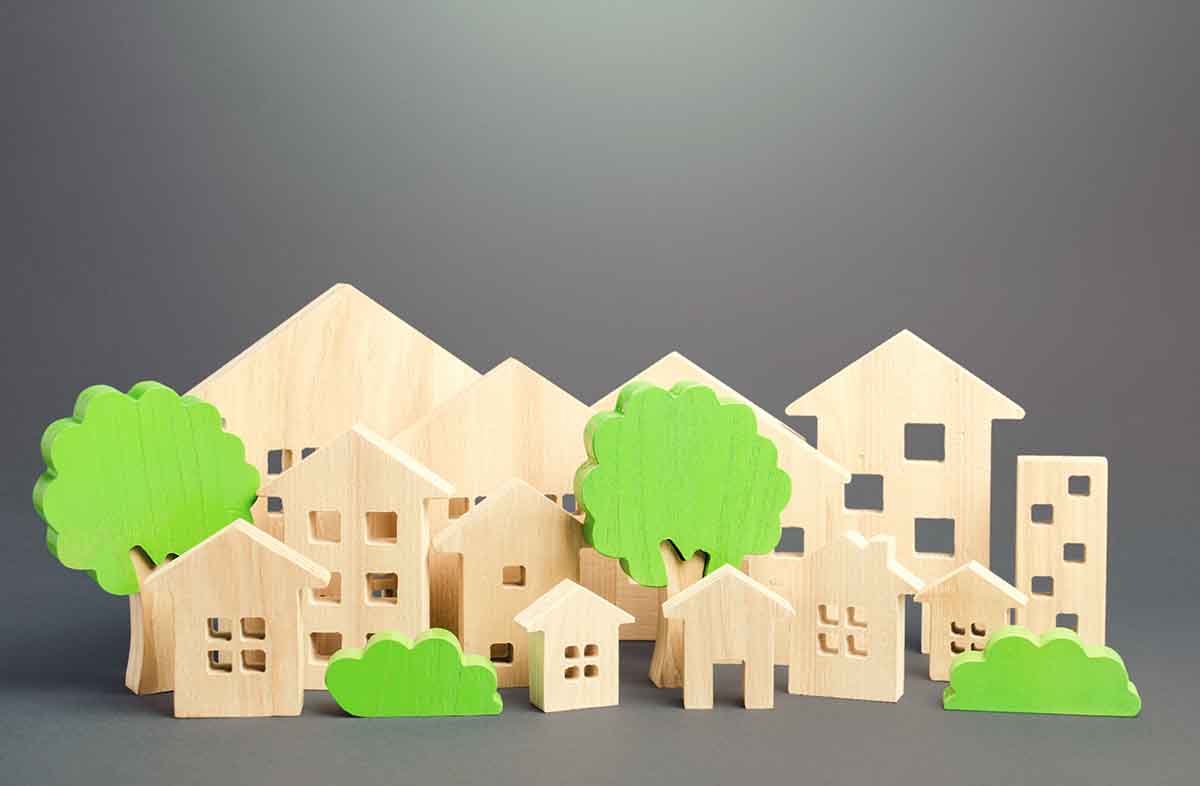 City of figures houses and green trees. Real estate concept. Urbanism and infrastructure. Realtor services. Infrastructure. Affordable housing. City greening. Effective town management.